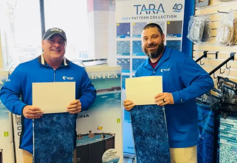 Blue Wave boys holding pool liners.