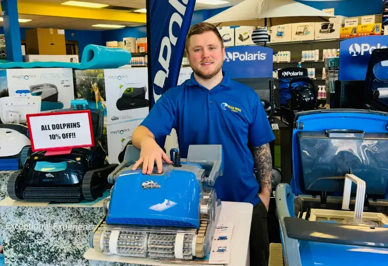 Blue Wave employee standing with Dolphin cleaners.
