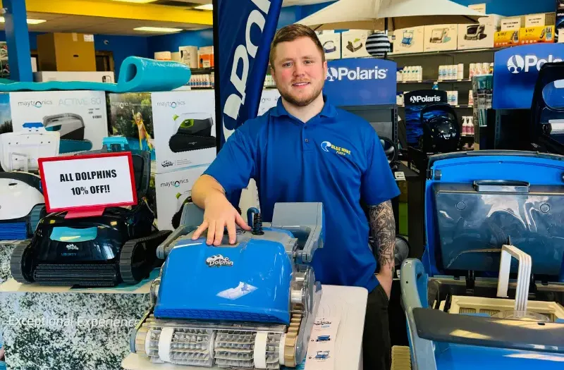 Blue Wave employee standing with Dolphin cleaners.