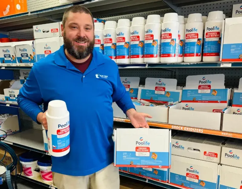 Blue Wave employee holding pool shock.