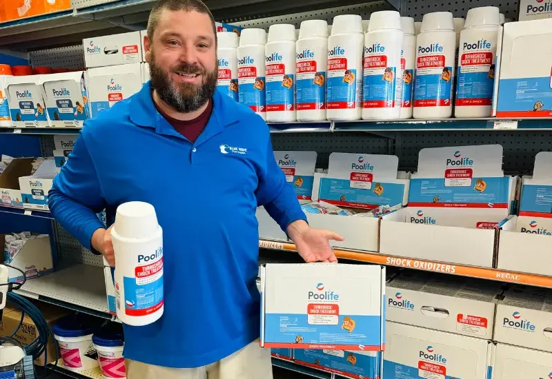 Blue Wave employee holding pool shock.