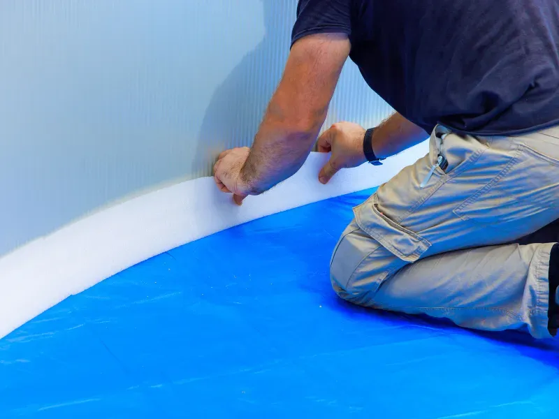 Man installing a pool liner.