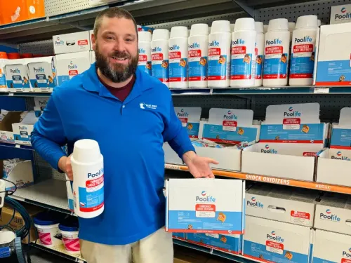 Blue Wave employee holding pool shock.