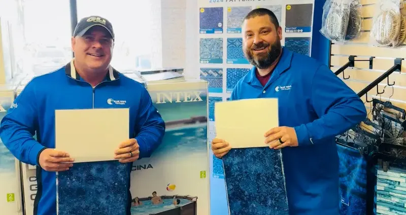 Blue Wave boys holding pool liners.