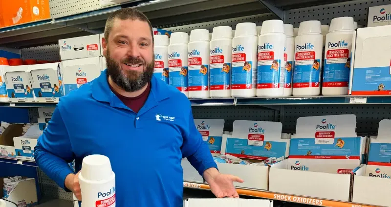 Blue Wave employee holding pool shock.