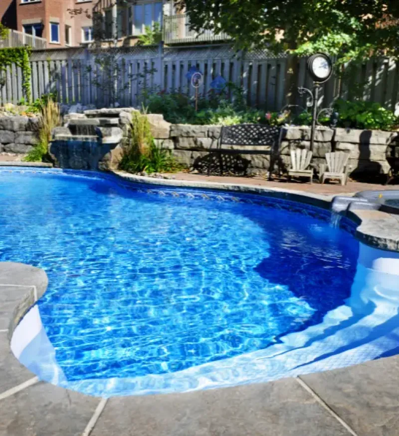 Pool in a nicely manicured backyard.