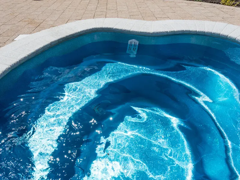 Light blue pool liner in a pool.